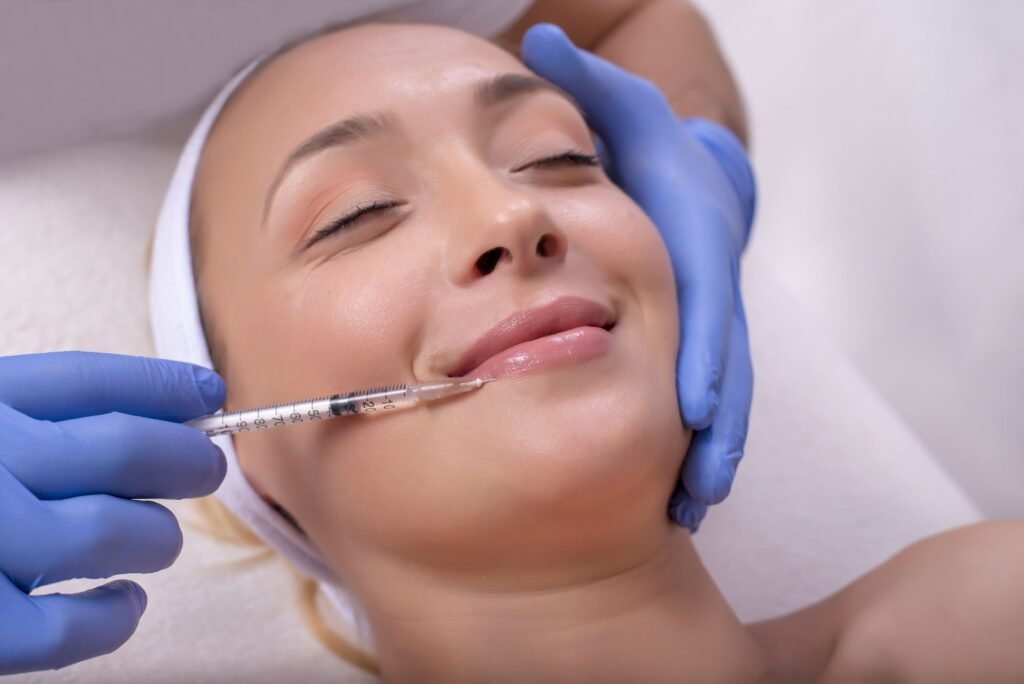 Beautiful young Caucasian female during skin treatment with hyaluronic acid in a beauty clinic